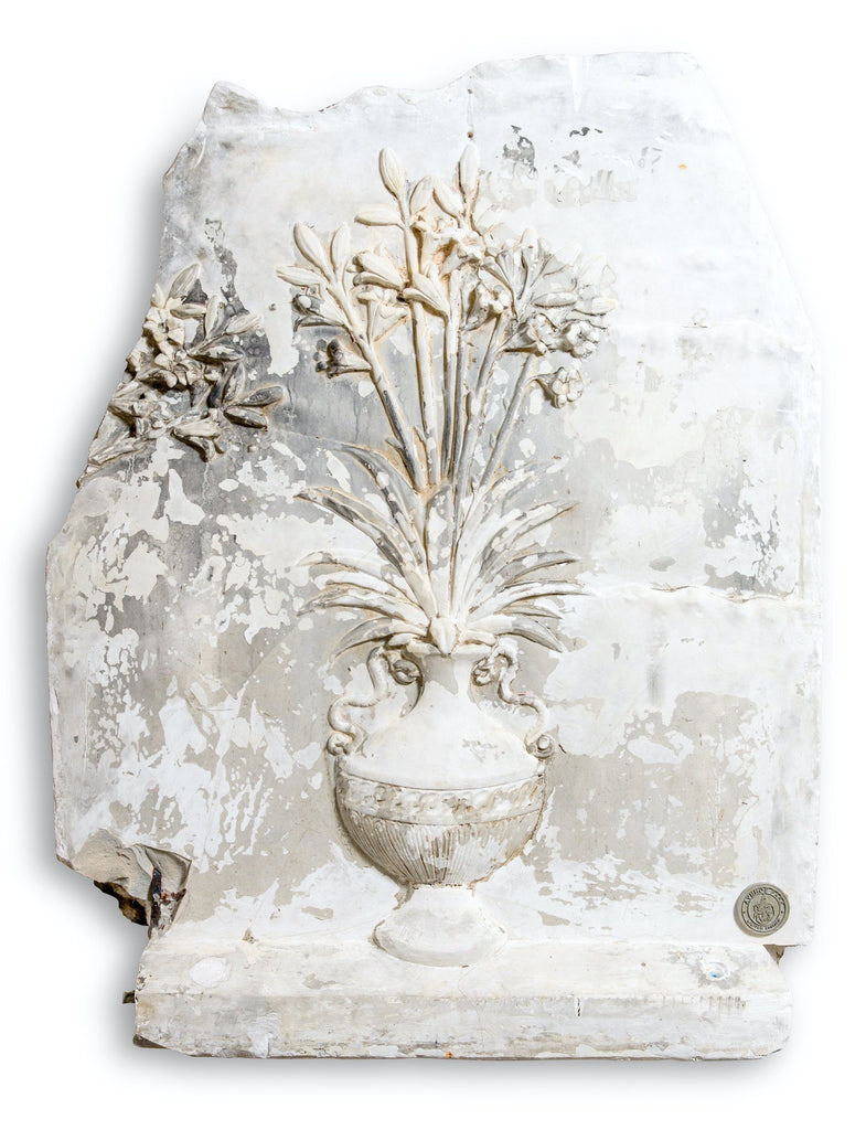 A plaster panel of a flowering vase
